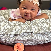 Kvori joined the competition — help win amazing prizes! baby, baby_girl, child, closeup, cozy, curly_hair, cushion, cute, expression, face, happy, headband, indoor, infant, lying_down, pacifier, patterned_fabric, portrait, smiling, soft_lighting