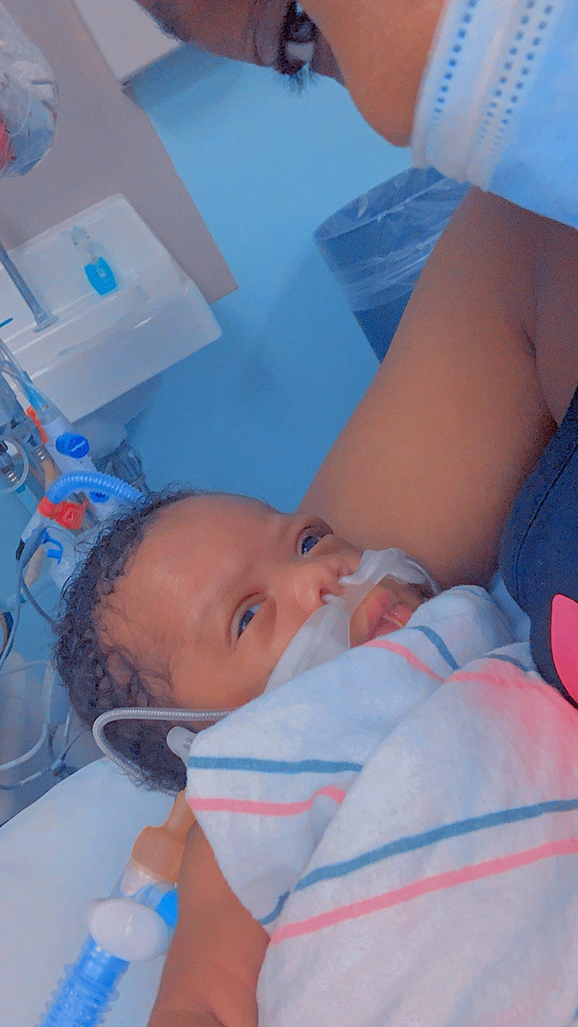 Zylee is registered to the contest to win money with this photo: abdomen, azure, baby, blue, cheek, chest, child, childbirth, comfort, elbow, hospital, human_leg, mouth, nose, patient, person, room, service, skin, toddler