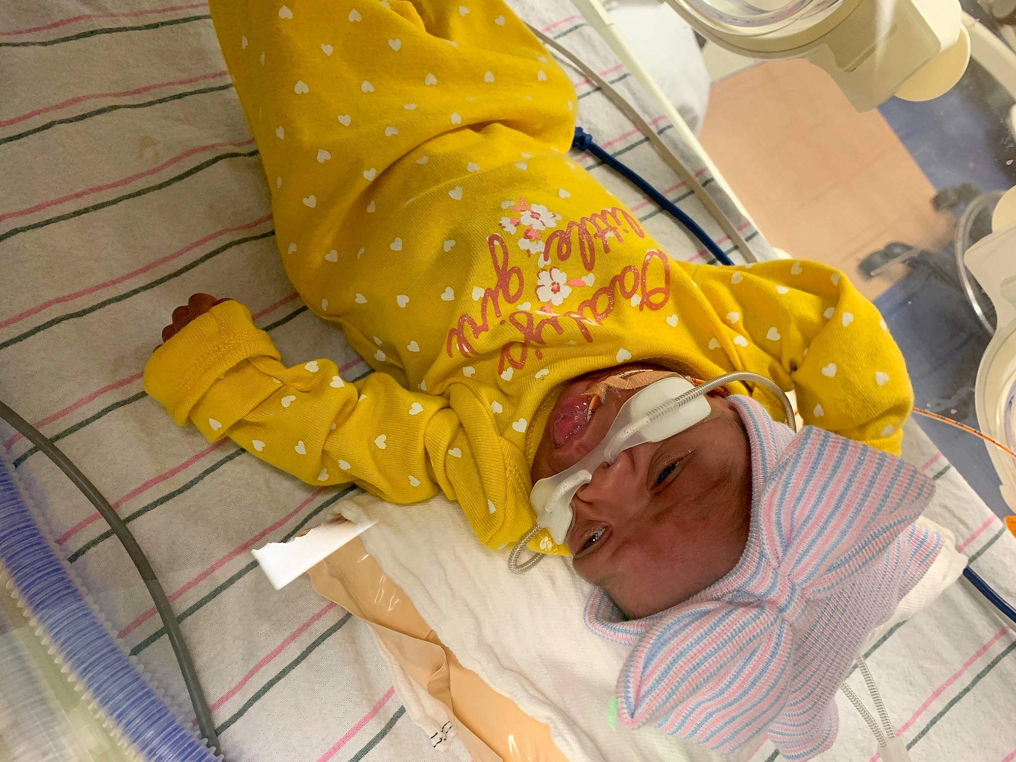 Zylee is registered to the contest to win money with this photo: chair, comfort, event, eyewear, flooring, fun, glasses, headwear, human_leg, linens, nail, pattern, person, personal_protective_equipment, room, service, sitting, sleeve, sunglasses, thigh