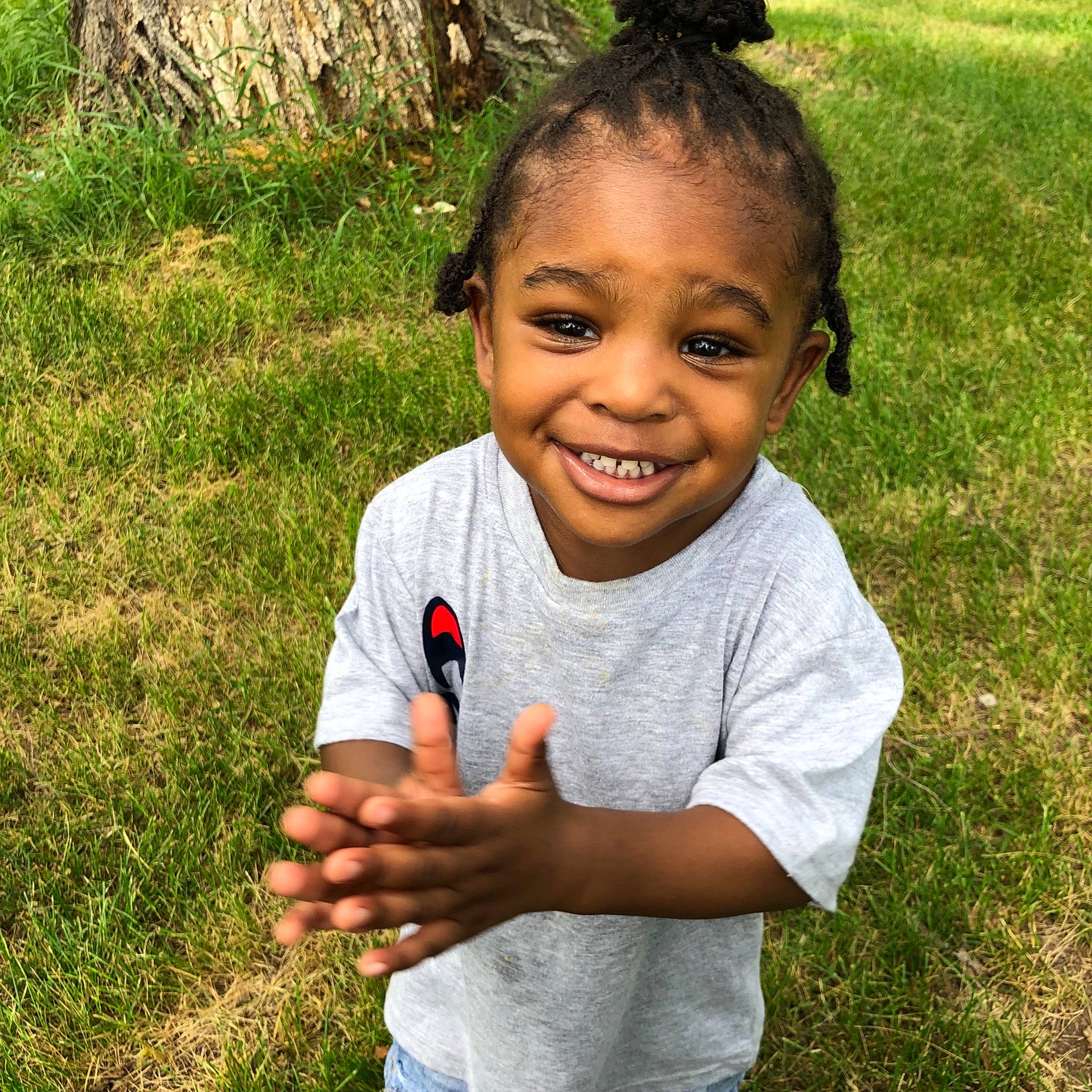 Lucious is registered to the contest to win money with this photo: adaptation, botany, child, face, finger, fun, gesture, grass, hand, happy, joy, leaf, lip, people, person, plant, play, smile, summer, thumb