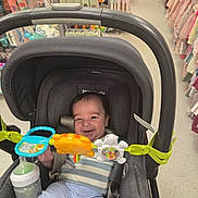 Isaac joined the competition — help win amazing prizes! baby, stroller, toy, smile, infant, baby_bottle, child, shopping_aisle, clothing, store, happy, seat, person, indoor, retail, baby_toy, baby_clothes, colorful, cute, young_child