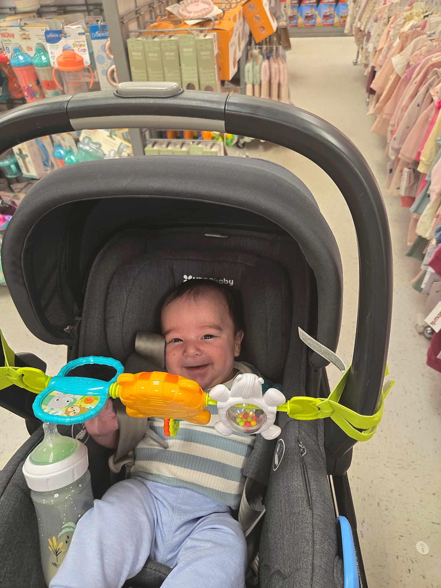 Isaac joined the competition — help win amazing prizes! baby, stroller, toy, smile, infant, baby_bottle, child, shopping_aisle, clothing, store, happy, seat, person, indoor, retail, baby_toy, baby_clothes, colorful, cute, young_child