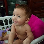 Clementine joined the competition — help win amazing prizes! baby, child, laundry_basket, blanket, indoor, smiling, cute, skin, hand, face, curious, sitting, furniture, wood, floor, home, young, infant, expression, room
