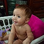 baby, child, laundry_basket, blanket, indoor, smiling, cute, skin, hand, face, curious, sitting, furniture, wood, floor, home, young, infant, expression, room
