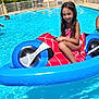Noursine participe au concours pour gagner de l'argent avec cette photo : child, girl, swimming_pool, inflatable_toy, float, water, summer, outdoor, trees, teepee_tents, sunlight, smiling, wet_hair, recreation, fun, play, vacation, poolside, blue, leisure