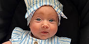 Delilah joined the competition — help win amazing prizes! baby, infant, child, person, blue_striped_clothing, headband, cute, portrait, hands, face, eyes, expression, sitting, black_background, soft_light, newborn, adorable, skin, small_hands, clothing