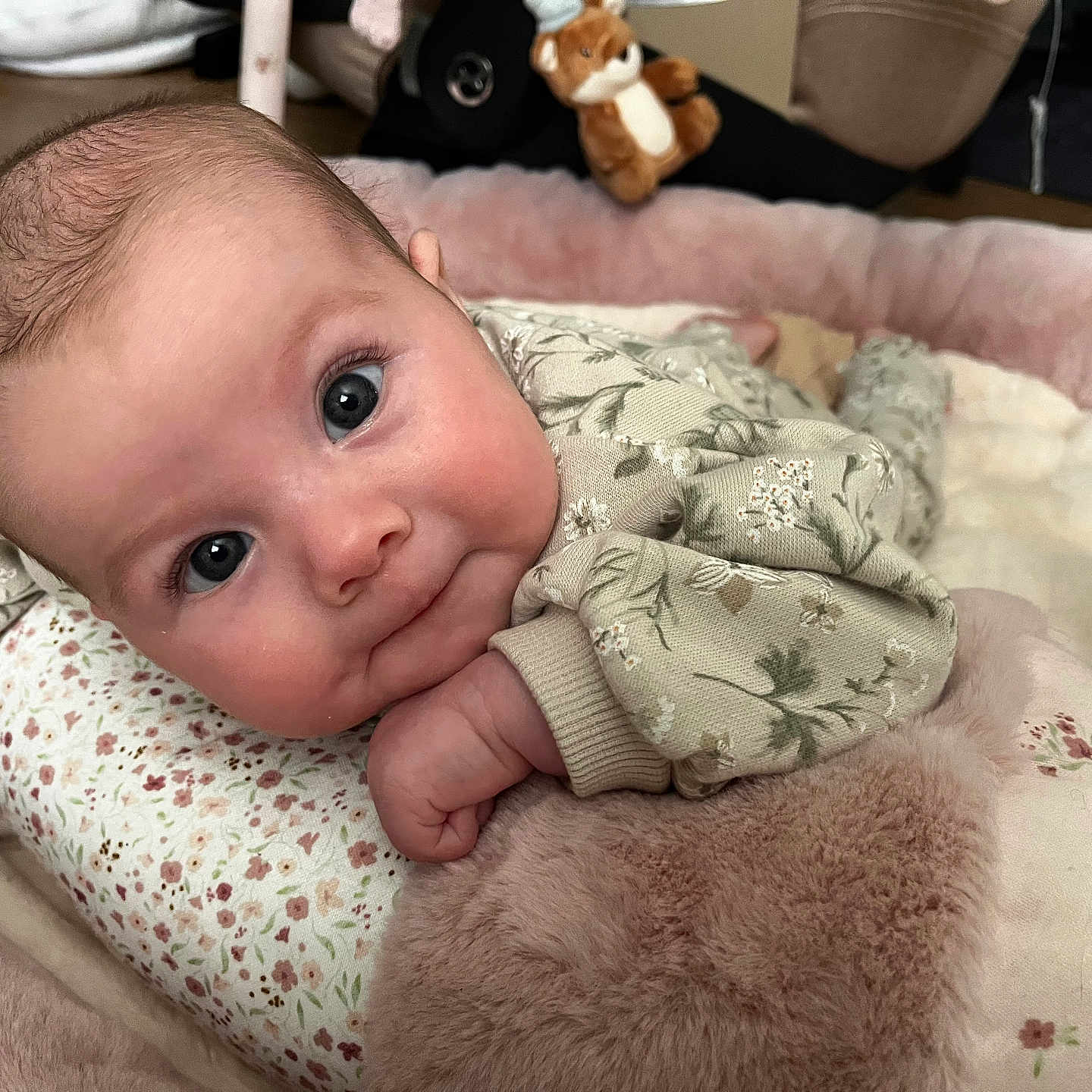 Florence is registered to the contest to win money with this photo: baby, blanket, child, clothing, couch, cute, eyes, face, flower_pattern, furniture, hand, head, indoor, infant, infant_clothing, plush, portrait, resting, skin, soft_toy