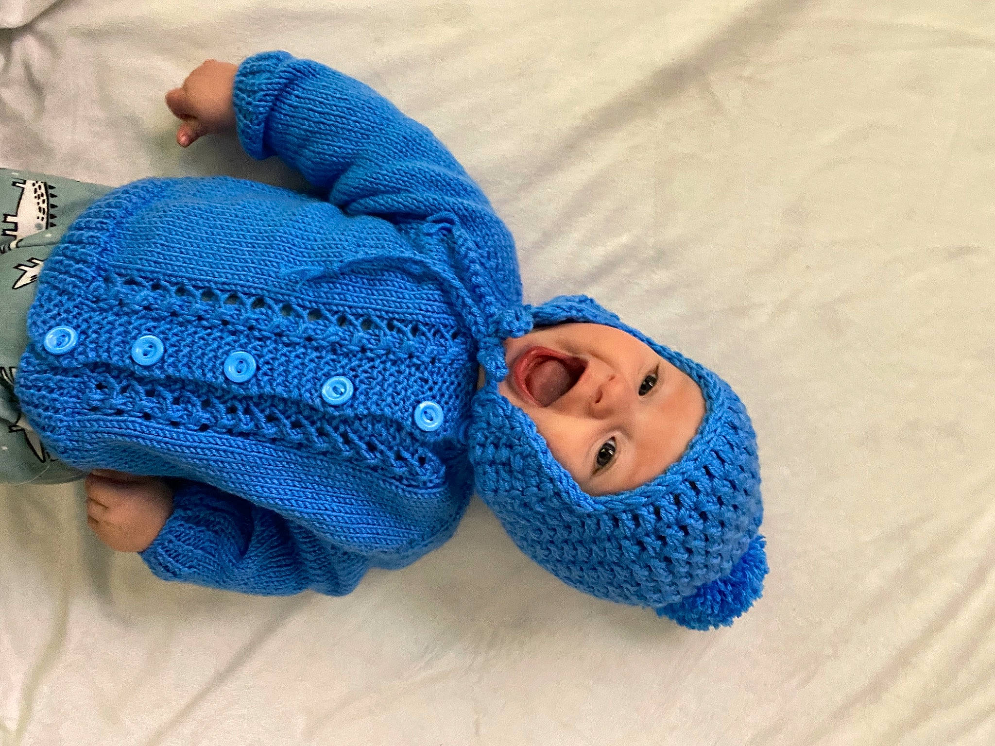 Callan is registered to the contest to win money with this photo: azure, baby, beanie, blue, bonnet, cap, child, clothing, cobalt_blue, crochet, electric_blue, headgear, headwear, knit_cap, knitting, outerwear, person, textile, toddler, turquoise