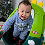 Datu joined the competition — help win amazing prizes! toddler, child, toy_car, green, yellow, blue_onesie, indoor, christmas_tree, holiday, smiling, face, furniture, carpet, playtime, happy, person, clothing, footwear, home, cheerful