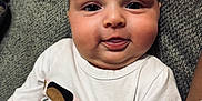 Elodie joined the competition — help win amazing prizes! baby, infant, face, tongue, expression, nirvana_shirt, clothing, couch, gray, texture, skin, person, cute, chubby, head, eyes, indoor, comfortable, young_child, happy