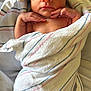 newborn, baby, infant, sleeping, wrapped, blanket, striped_blanket, soft_texture, peaceful, cute, human, portrait, closeup, delicate, tiny_hands, resting, indoors, skin, head, face