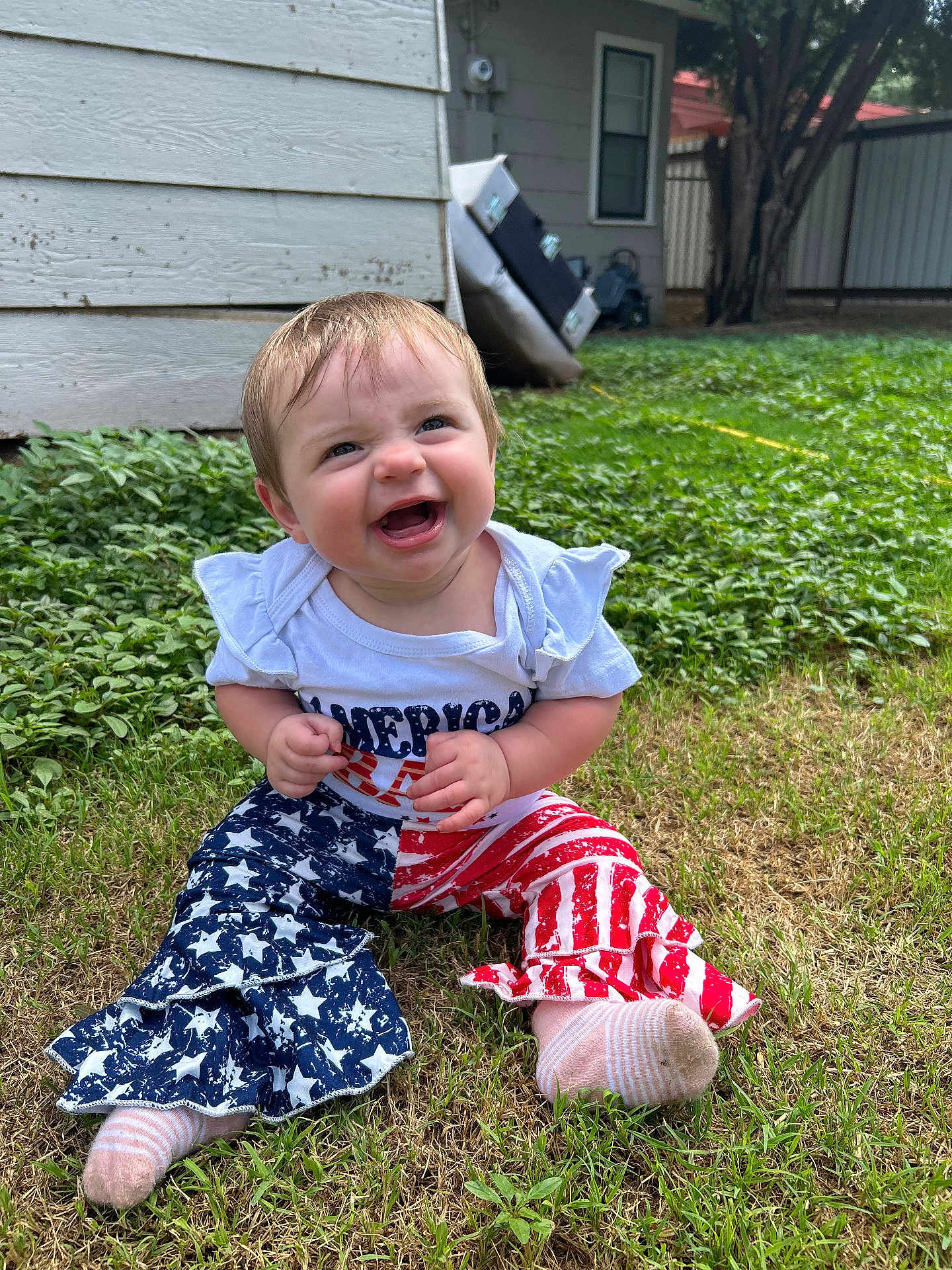 Cambreigh joined the competition — help win amazing prizes! baby, child, grass, outdoor, smiling, happy, pants, stars, stripes, sock, shirt, person, nature, greenery, yard, house, window, tree, cute, infant