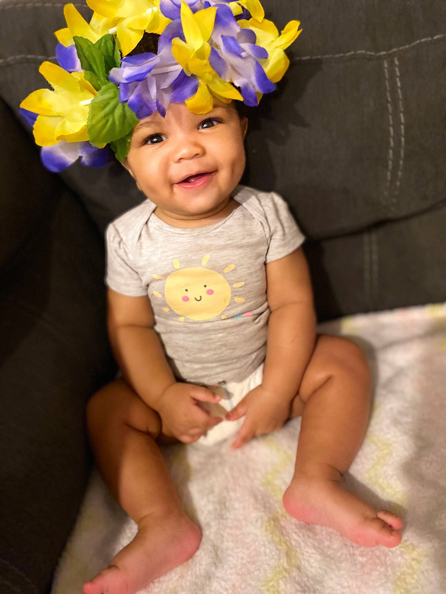 Azariah is registered to the contest to win money with this photo: ankle, artificial_flower, baby, baby_toddler_clothing, barefoot, costume_accessory, cut_flowers, foot, hair_accessory, headband, headwear, iris, living_room, mouth, nose, party_supply, person, petal, toddler, toe