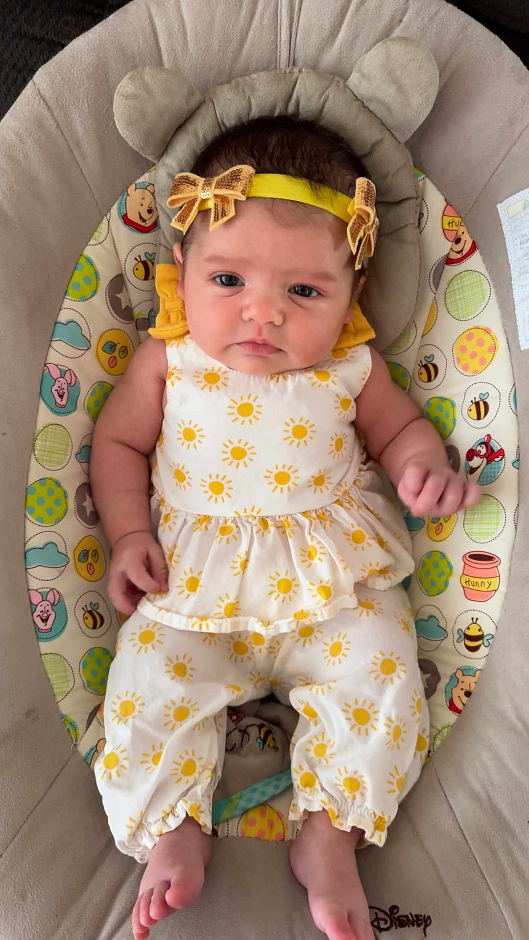 Everleigh joined the competition — help win amazing prizes! baby, infant, child, yellow, headband, bows, sun_pattern, onesie, baby_seat, disney, cute, comfort, indoors, clothing, feet, hand, face, portrait, soft, resting