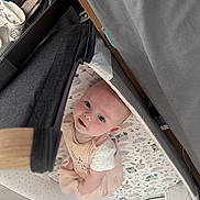 Autumn Bolding joined the competition — help win amazing prizes! baby, infant, playpen, patterned_bedding, soft_fabric, curious, looking_up, indoors, child, cute, person, newborn, pink_clothing, white_shirt, crib, floor, home, smiling, face, young_child