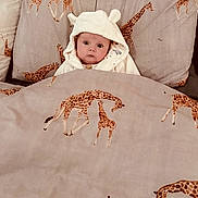 Autumn Bolding joined the competition — help win amazing prizes! animal_print, baby, bed, blanket, child, comfort, cozy, cute, giraffe_pattern, hooded_clothing, indoor, infant, person, pillow, portrait, resting, sleepwear, soft_fabric, wide_eyes, young_child