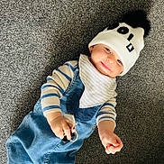 Austin is registered to the contest to win money with this photo: toddler, child, baby, carpet, beanie, hat, pom_pom, denim_overalls, striped_shirt, keys, smile, face, hand, indoor, cute, happy, clothing, infant, playful, portrait