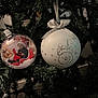 christmas_tree, ornament, bauble, baby_photo, baby, teddy_bear, santa_hat, ribbon, decoration, holiday, festive, greenery, pine_needles, celebration, cute, child, toy, seasonal, close_up, indoor