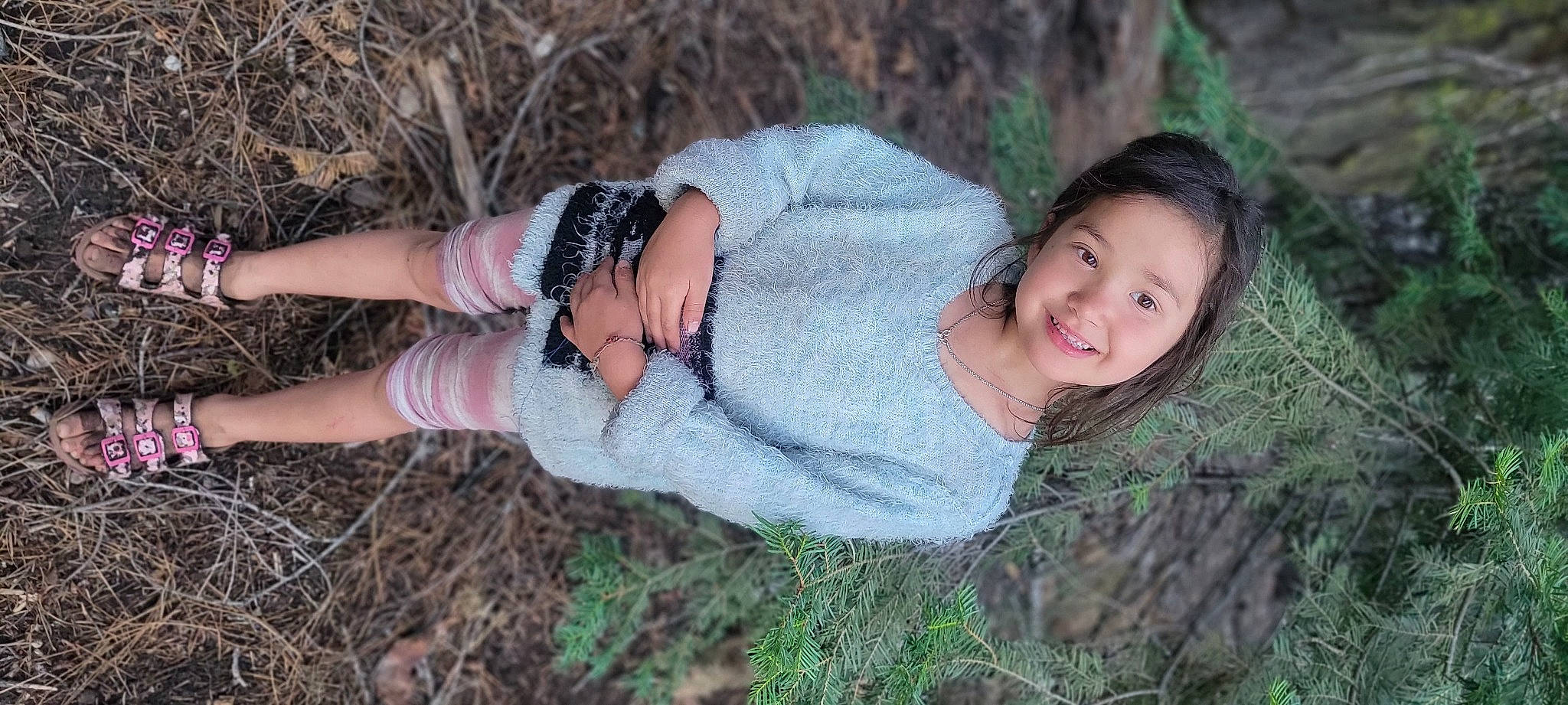 Lyla is registered to the contest to win money with this photo: arm, eye, face, fawn, finger, gesture, grass, grass_family, hand, happy, head, human_body, joy, people_in_nature, person, plant, skin, smile, textile, tree