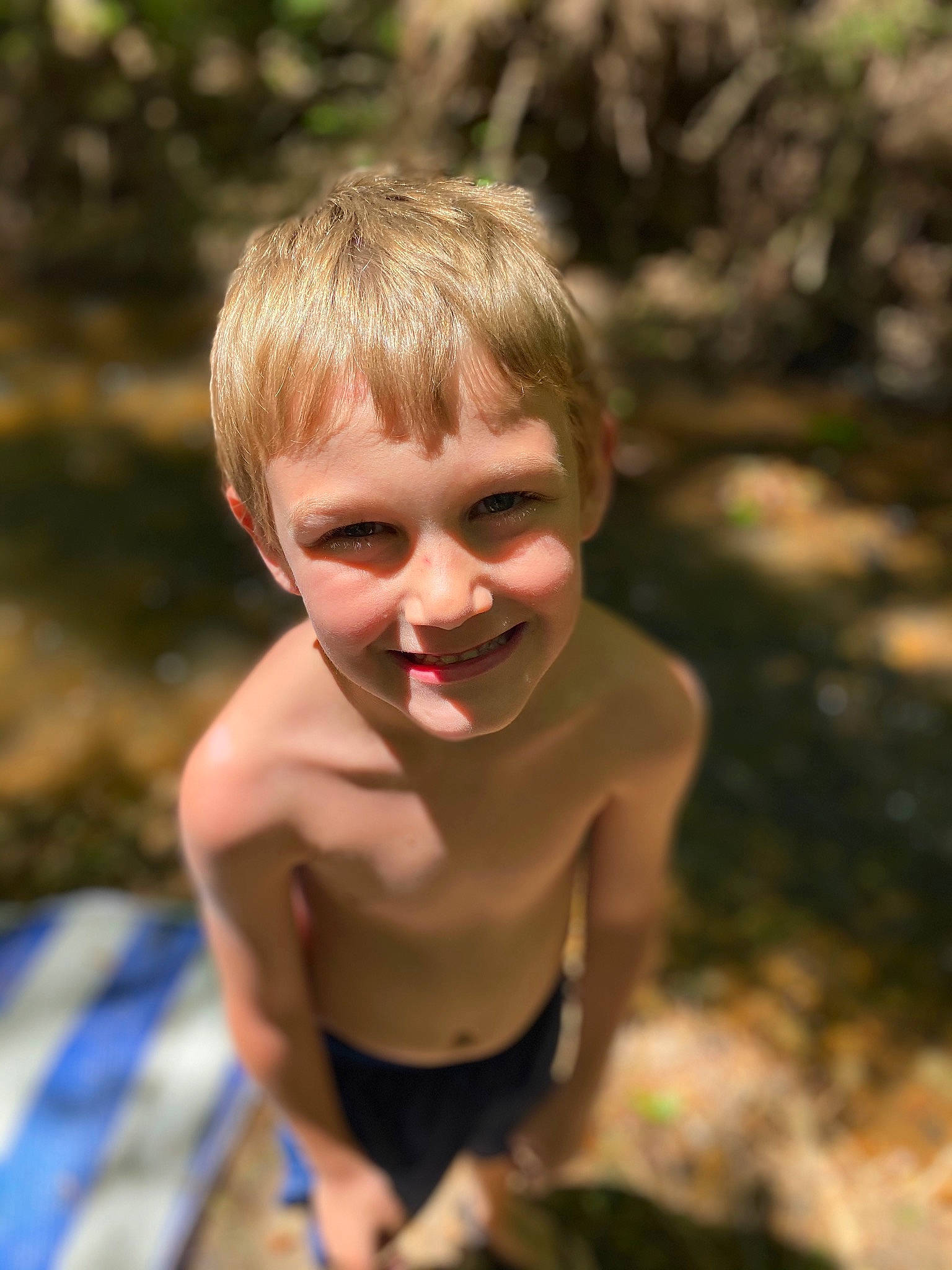 Conner is registered to the contest to win money with this photo: barechested, blond, chest, child, eye, flash_photography, fun, grass, hair, happy, joy, leisure, people_in_nature, person, plant, recreation, smile, soil, swimwear, toddler