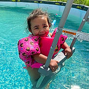 Eliyana is registered to the contest to win money with this photo: child, clothing, face, female, girl, head, leisureactivities, lifejacket, outdoors, person, photography, pool, portrait, sport, summer, swimming, swimmingpool, swimwear, vest, water
