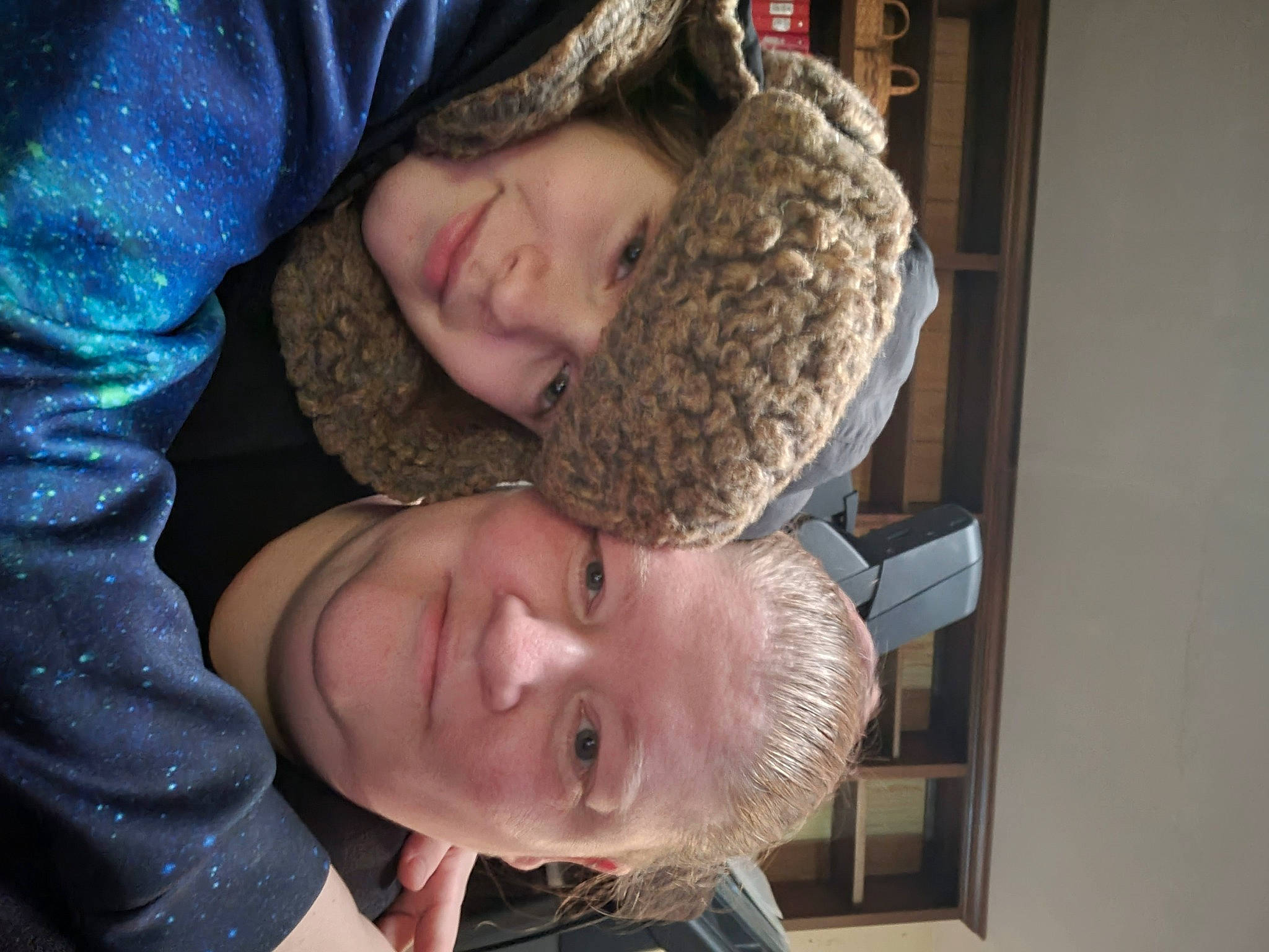 Malcolm is registered to the contest to win money with this photo: beard, cap, child, ear, facial_hair, fun, fur, happy, headwear, joy, organ, person, selfie, smile, tree, winter