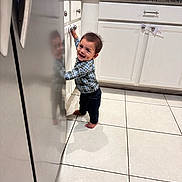 Lorenzo joined the competition — help win amazing prizes! toddler, child, smiling, barefoot, kitchen, cabinet, refrigerator, reflection, tile_floor, plaid_shirt, jeans, person, indoor, home, happy, young_child, curly_hair, standing, domestic, casual_clothing