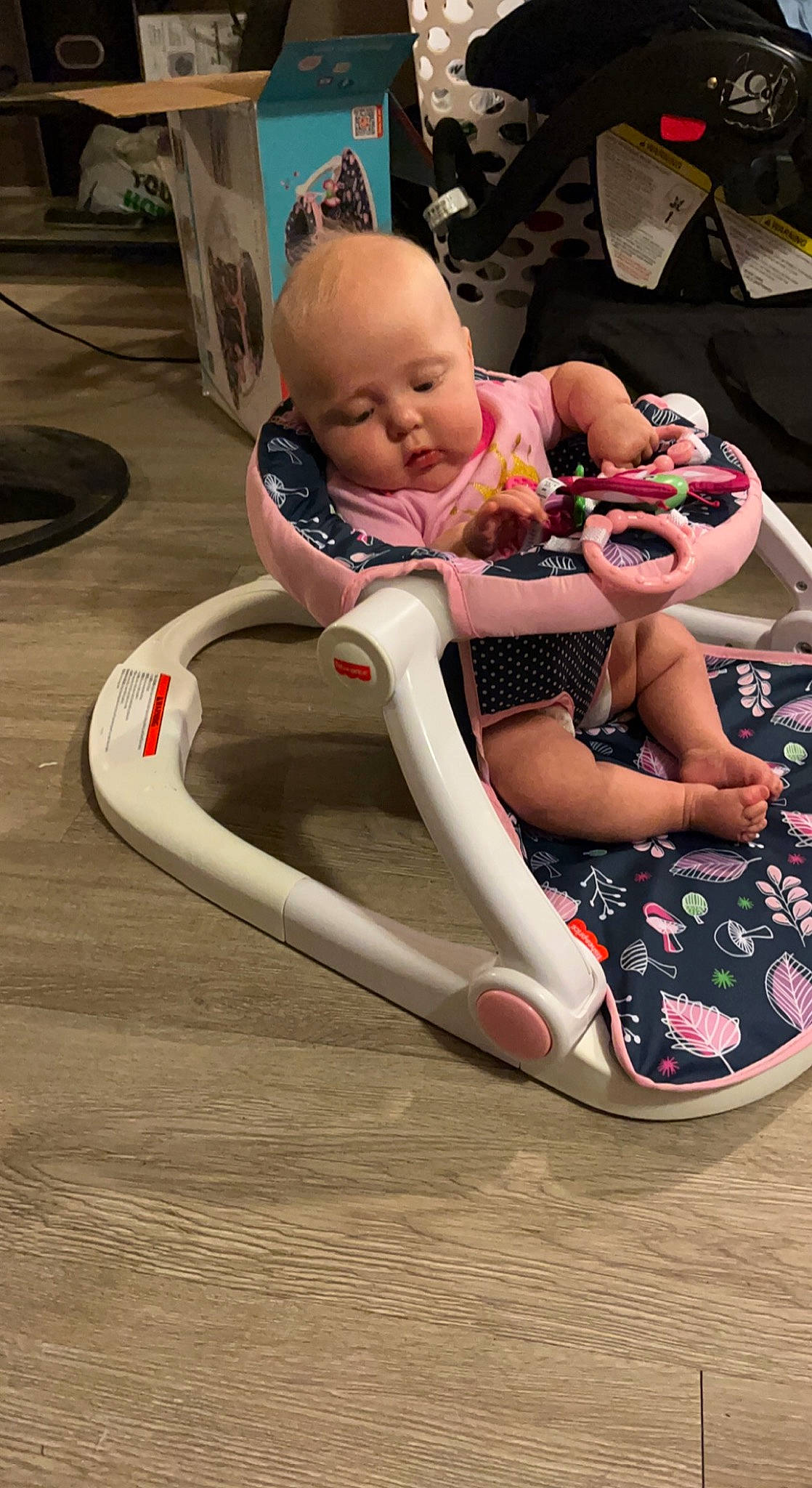Katie is registered to the contest to win money with this photo: automotive_design, baby, baby_carriage, baby_products, baby_safety, baby_toddler_clothing, child, comfort, event, eyewear, fun, happy, human_leg, leisure, person, pink, sandal, sitting, skin, thigh