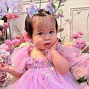 Elsie joined the competition — help win amazing prizes! toddler, child, dress, lavender, butterfly_hair_clips, flowers, pink, purple, cute, portrait, indoor, decor, baby, hand_on_face, curious_expression, soft_lighting, fairy_tale, costume, young_child, smiling