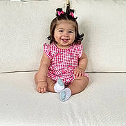 Arabella joined the competition — help win amazing prizes! baby, child, smiling, sitting, couch, pink_bows, short_sleeves, watermelon_print, socks, indoor, cute, happy, person, portrait, hair_bows, infant, plaid, furniture, skin, face