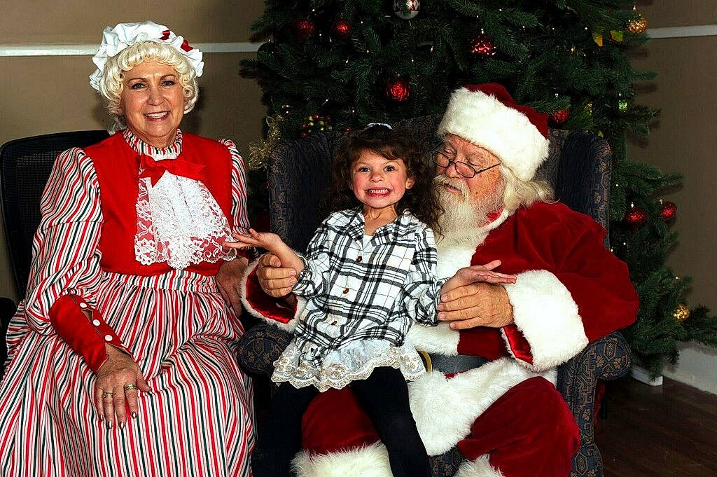 Gabby joined the competition — help win amazing prizes! christmas, christmas_decoration, christmas_eve, christmas_ornament, christmas_tree, costume, event, fictional_character, fur, headwear, holiday, joy, lap, person, santa_claus, tradition