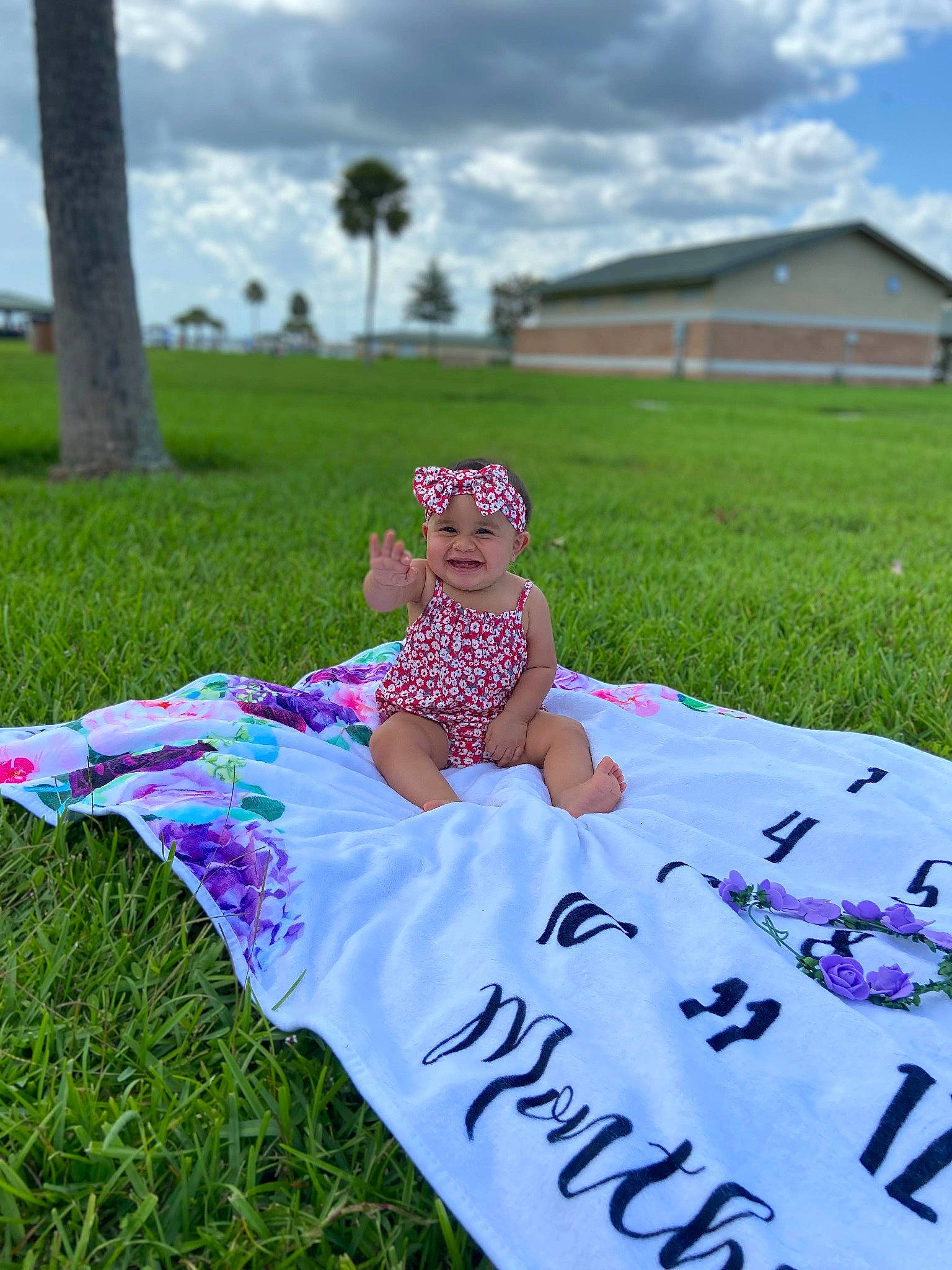 Khaleesi is registered to the contest to win money with this photo: baby, baby_toddler_clothing, cloud, dress, event, grass, grassland, happy, hat, headwear, joy, leisure, magenta, meadow, palm_tree, people_in_nature, person, pink, plant, sky