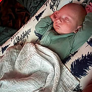 Teddy is registered to the contest to win money with this photo: baby, sleeping, blanket, pillow, infant, cozy, bed, rest, peaceful, child, soft, comfort, cute, indoors, portrait, young, fabric, relax, peace, nap