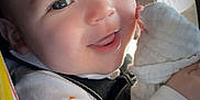 Liam joined the competition — help win amazing prizes! baby, child, smiling, face, car_seat, safety_harness, blanket, clothing, infant, cute, happy, portrait, seatbelt, indoors, closeup, person, expression, soft_light, warning_label, snuggle