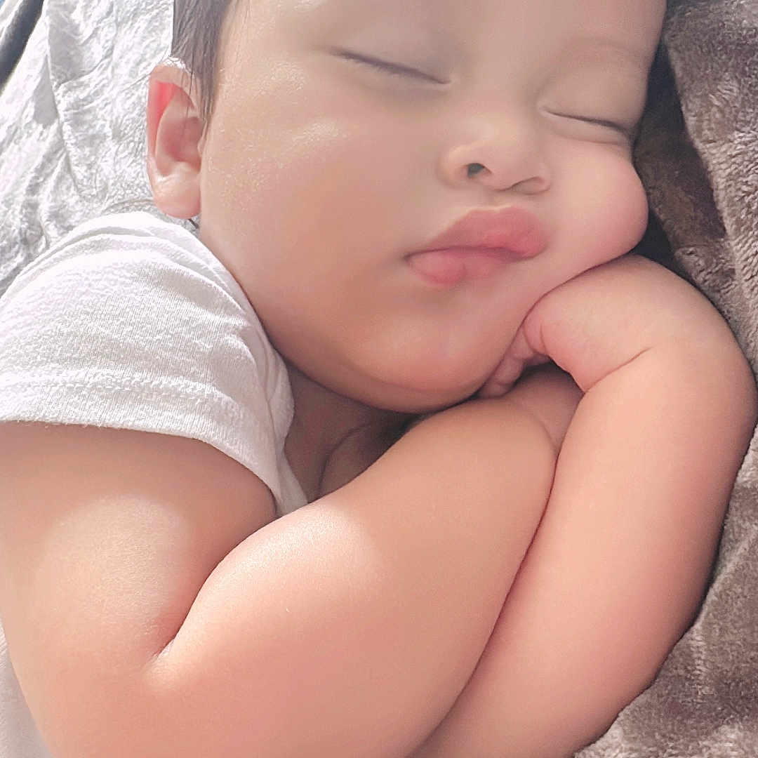 Juian T Lopez is registered to the contest to win money with this photo: baby, bed, bedroom, blanket, cushion, face, furniture, happy, head, homedecor, indoors, newborn, person, photography, portrait, room, skin, sleeping, smile, towel