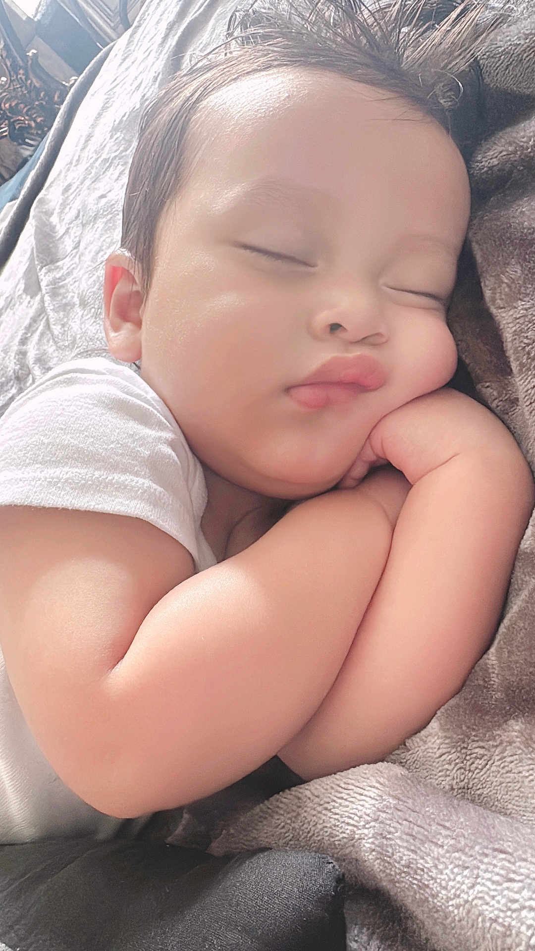 Juian T Lopez is registered to the contest to win money with this photo: baby, bed, bedroom, blanket, cushion, face, furniture, happy, head, homedecor, indoors, newborn, person, photography, portrait, room, skin, sleeping, smile, towel