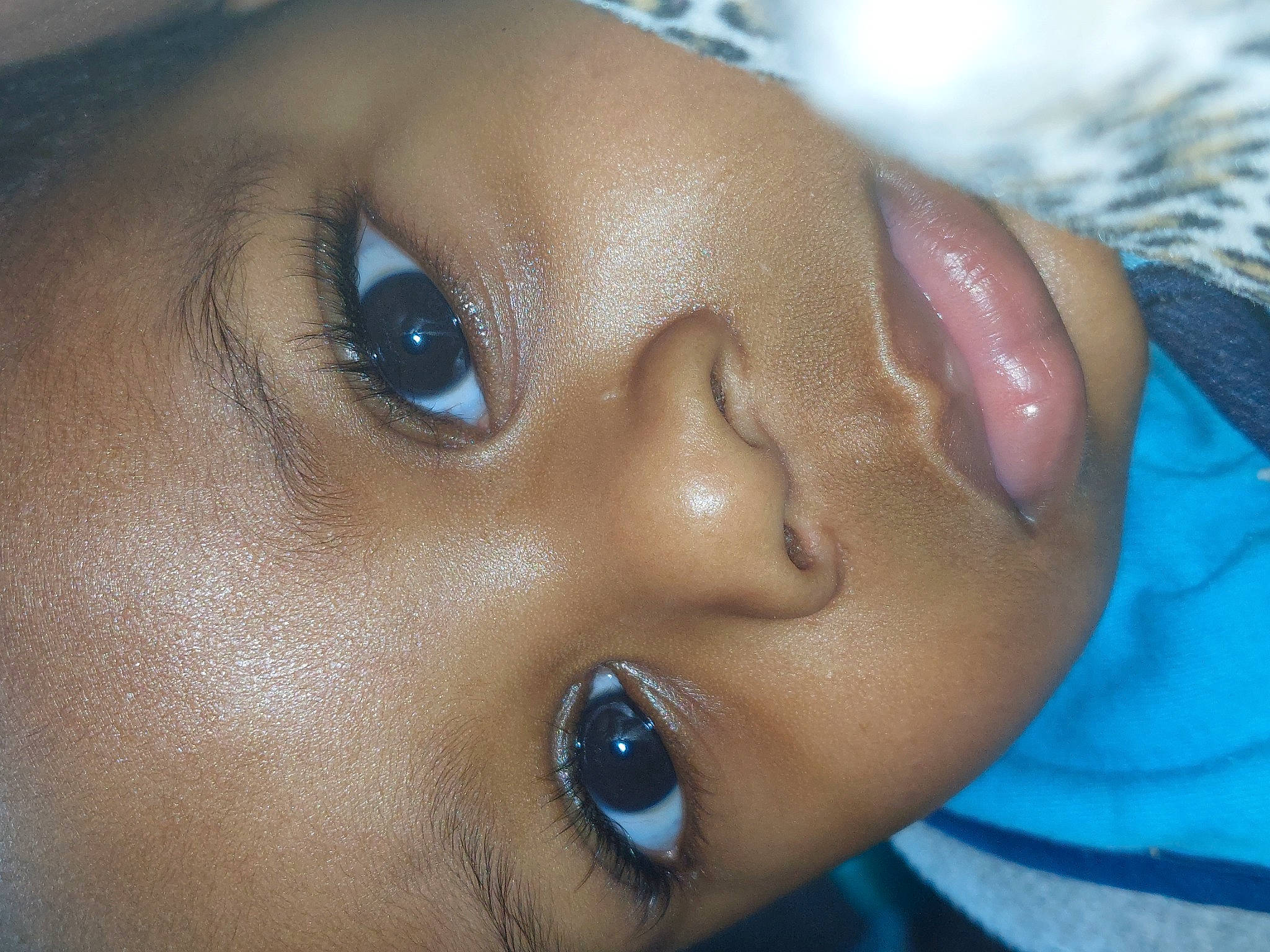 Kingson is registered to the contest to win money with this photo: baby, cheek, child, close_up, ear, electric_blue, eyelash, fun, happy, human_body, iris, lip, macro_photography, no_expression, nose, person, portrait_photography, skin, smile, toddler