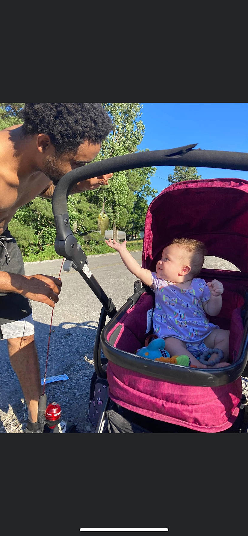 Zaylor is registered to the contest to win money with this photo: baby_carriage, baby_products, child, electric_blue, event, fun, grass, happy, lap, leisure, microphone, motor_vehicle, person, recreation, shorts, sitting, tire, toddler, travel, tree