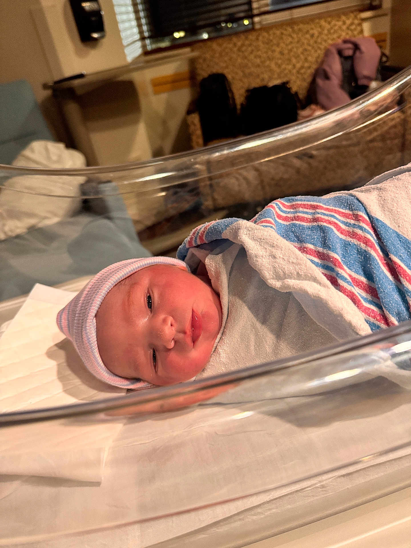 Ethan is registered to the contest to win money with this photo: newborn, baby, hospital, bassinet, blanket, hat, infant, bed, resting, wrapped, person, face, sleeping, indoor, medical, nursery, cute, peaceful, newborn_baby, portrait