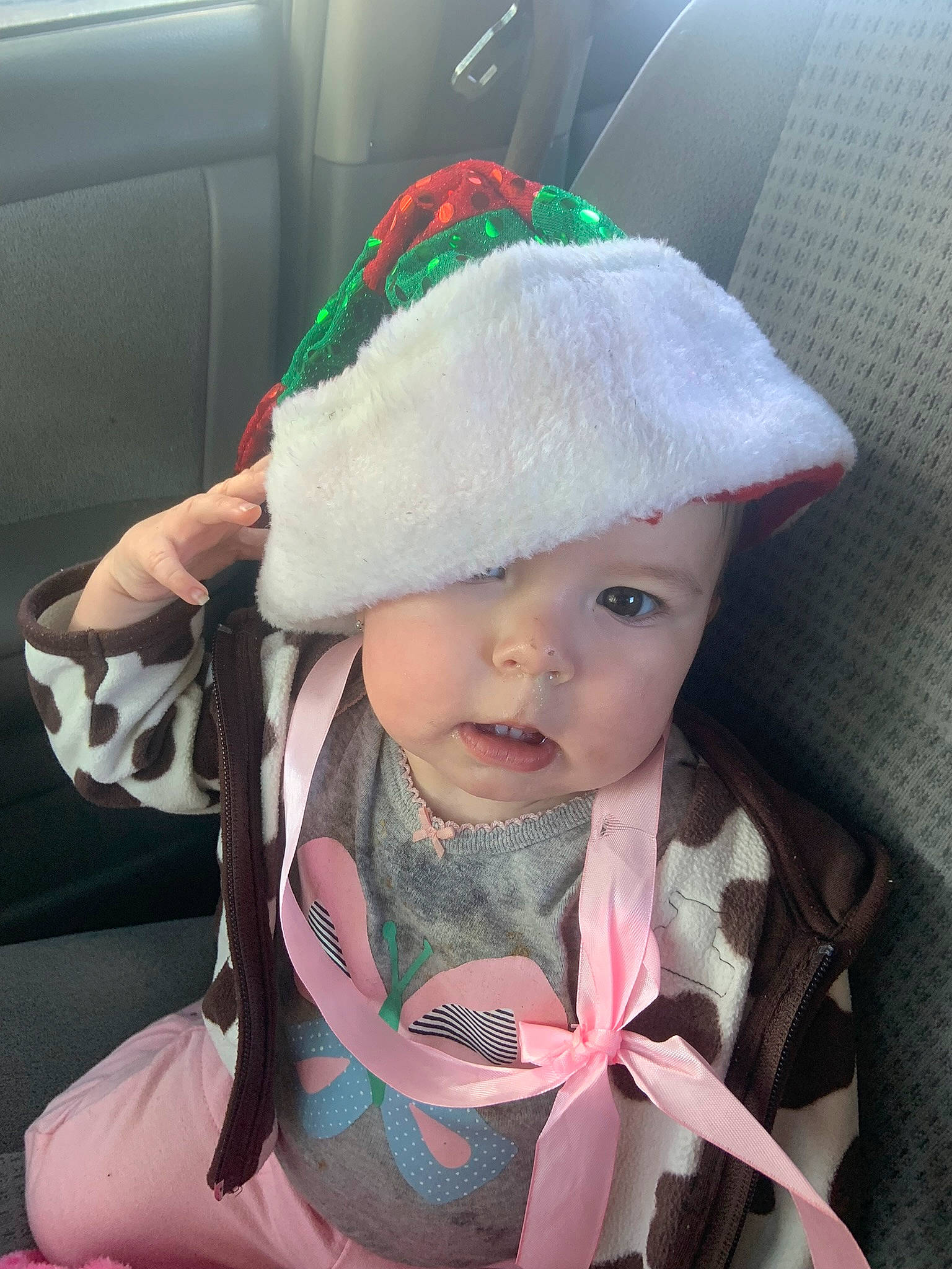 Emersyn is registered to the contest to win money with this photo: baby, baby_toddler_clothing, cap, child, christmas, christmas_eve, comfort, costume_hat, event, fashion_accessory, green, hat, head, headgear, headwear, holiday, lap, pattern, person, sun_hat