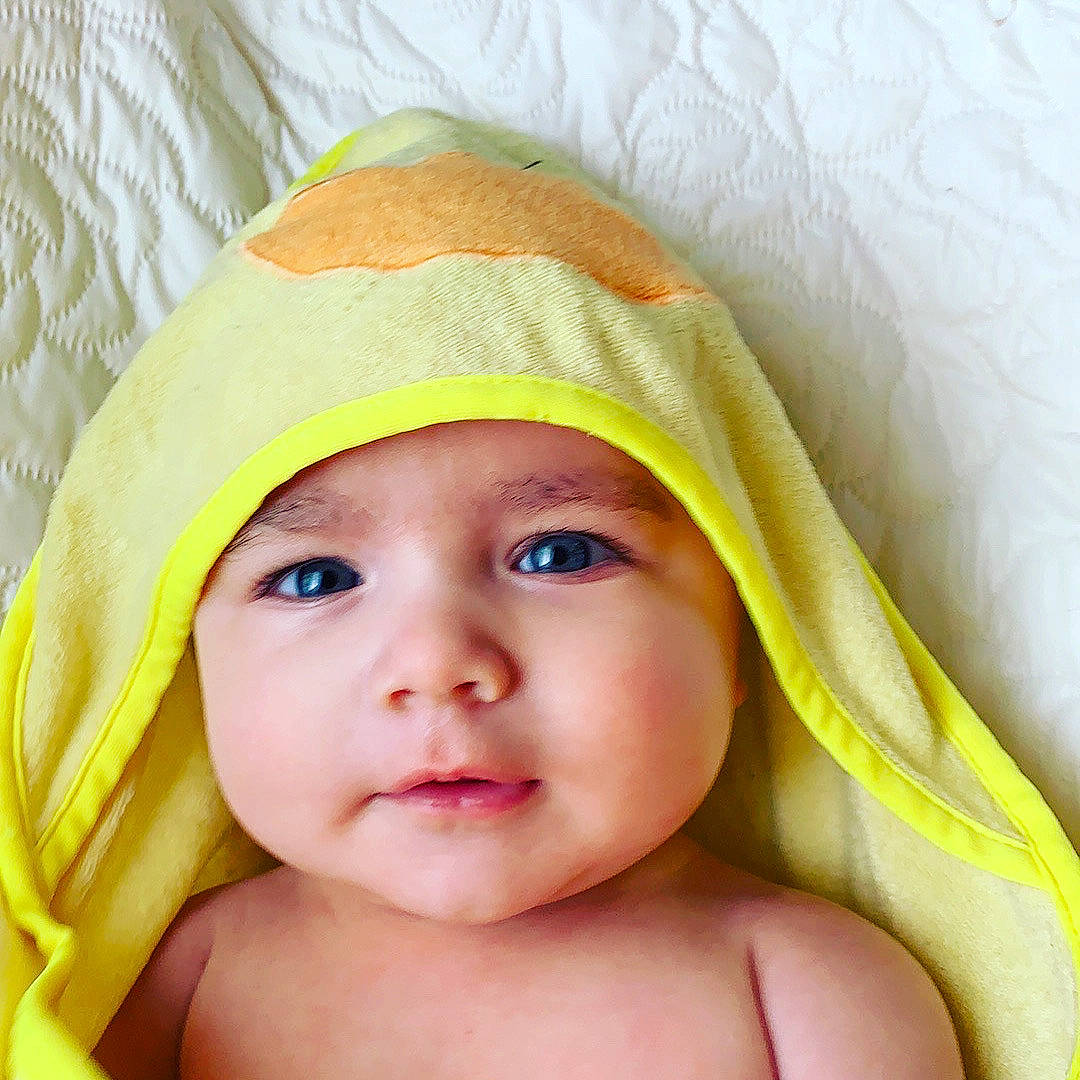Braden is registered to the contest to win money with this photo: baby, child, close_up, eye, face, head, headgear, headwear, lip, nose, person, portrait_photography, skin, smile, toddler, yellow