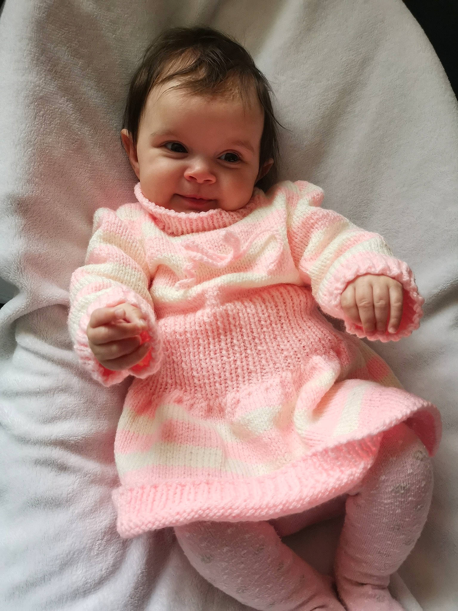 Deborah participe au concours pour gagner de l'argent avec cette photo : arm, baby, baby_toddler_clothing, cheek, chin, comfort, dress, eye, hand, human_body, iris, lip, neck, nose, outerwear, person, product, skin, sleeve, smile