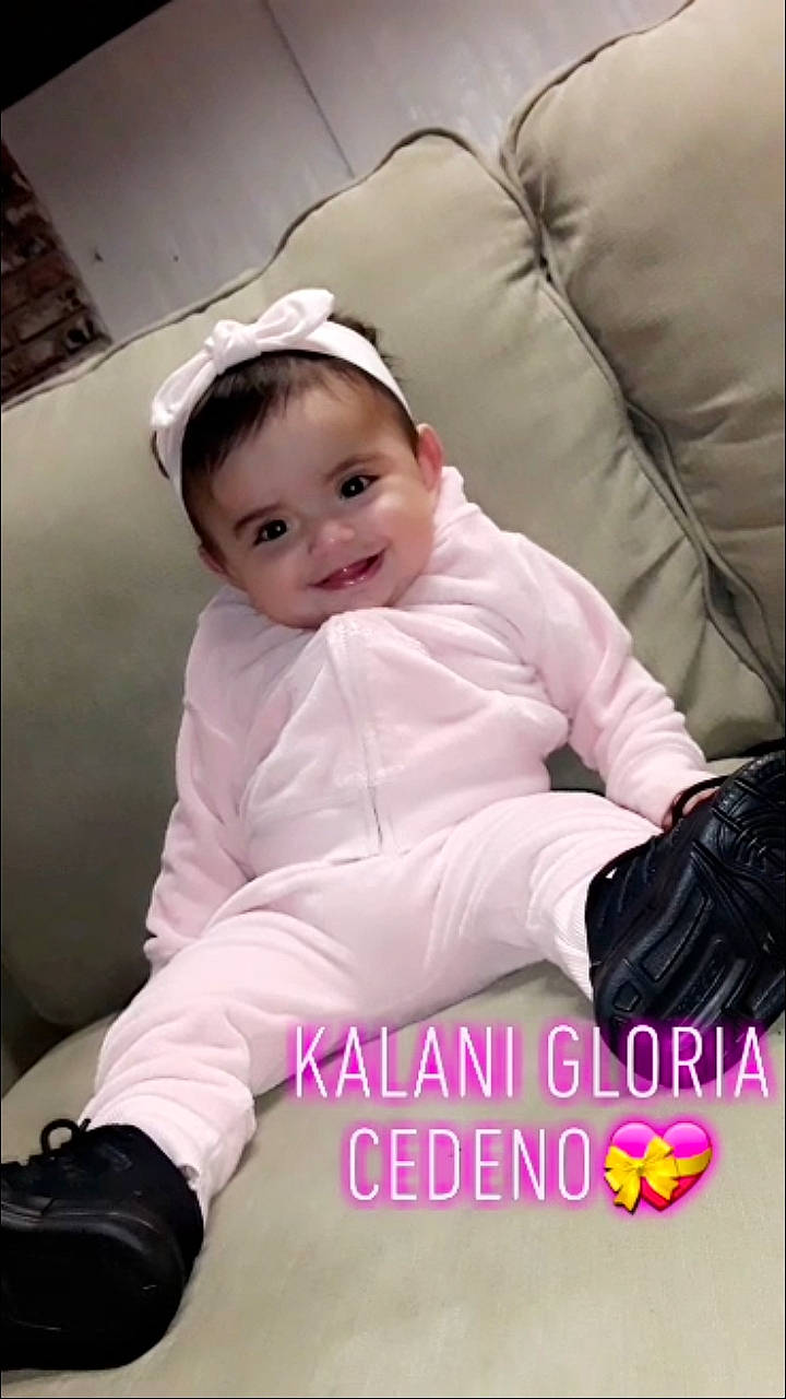 Kalani is registered to the contest to win money with this photo: arm, baby, baby_toddler_clothing, cheek, child, child_model, hair_accessory, headband, headgear, joy, person, photo_caption, photography, pink, skin, sleeve, smile, toddler