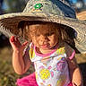 Kehlani is registered to the contest to win money with this photo: bodypart, bonnet, cap, child, clothing, costume, dress, face, female, finger, girl, grass, hand, hat, head, person, photography, portrait, skirt, sunhat