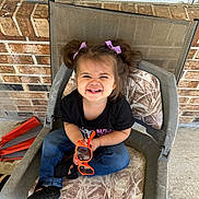 Kehlani is registered to the contest to win money with this photo: accessories, chair, child, clothing, couch, face, female, footwear, furniture, girl, glasses, happy, head, jeans, laughing, pants, person, photography, portrait, shoe