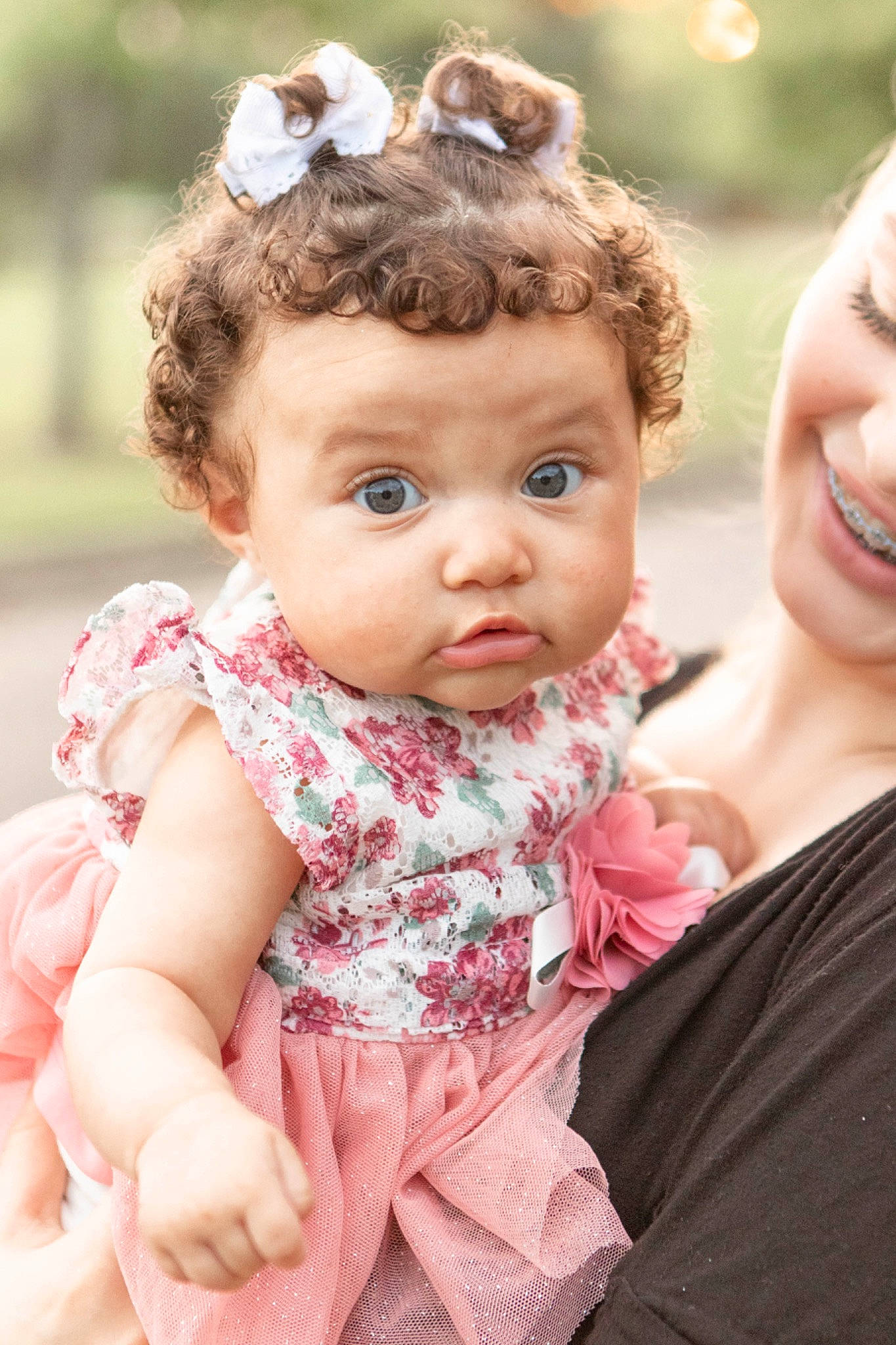 Everleigh joined the competition — help win amazing prizes! baby_toddler_clothing, cheek, dress, eye, facial_expression, gesture, grass, hair, hairstyle, happy, head, iris, lip, person, pink, plant, shoulder, skin, sleeve, smile