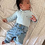 baby, infant, child, clothing, denim, jeans, polo_shirt, blue, patterned_blanket, lying_down, curious, face, hair, foot, hand, casual, indoor, soft_light, portrait, young