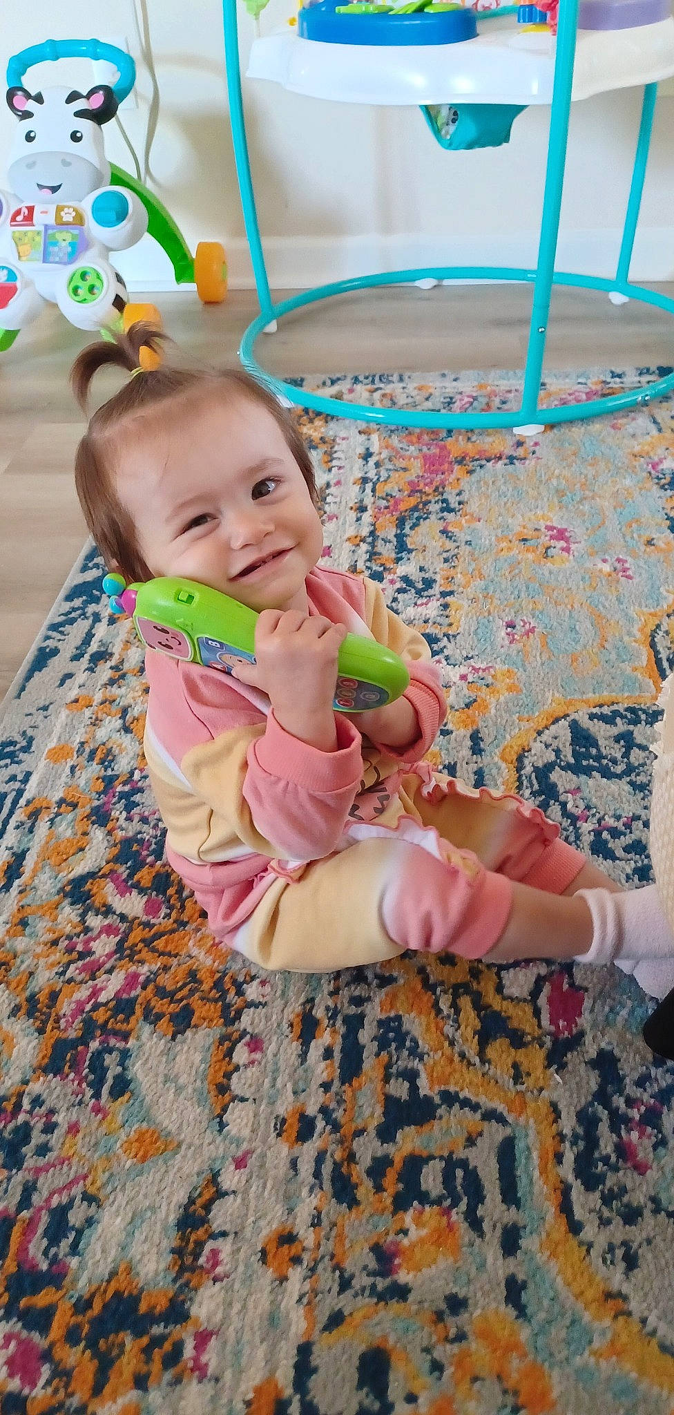 Harlow is registered to the contest to win money with this photo: baby, baby_products, baby_toddler_clothing, cheek, child, comfort, finger, flooring, fun, happy, head, joy, leisure, linens, pattern, person, pink, sitting, skin, sock