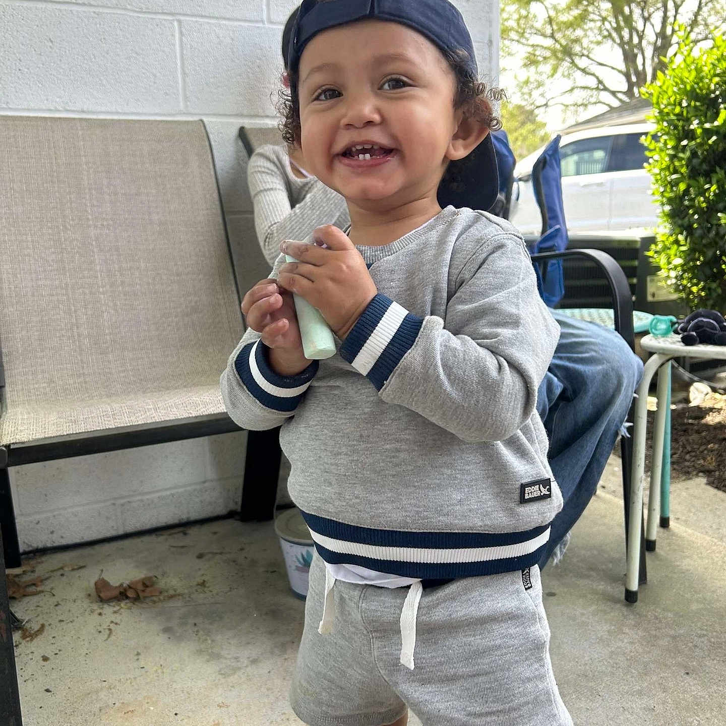 Liam is registered to the contest to win money with this photo: baby, baseballcap, cap, clothing, coat, cream, dessert, face, food, happy, hat, head, icecream, jacket, pants, person, photography, portrait, shorts, sitting