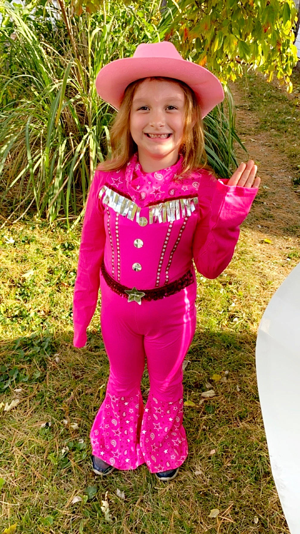 Kaylee is registered to the contest to win money with this photo: child, eye, face, fun, grass, happy, hat, headwear, joy, leaf, magenta, outerwear, people_in_nature, person, personal_protective_equipment, pink, plant, purple, recreation, sleeve
